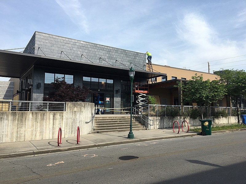 Workers remodel the former Grocery Bar at Long and Main Street into new Five Wits Brewing Co., scheduled to open this fall.
