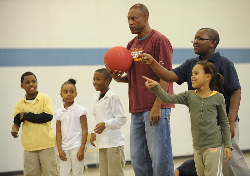 Staff Photo by Allison Kwesell /
Cornelius Carr, 12, top right, and Asha Lee, 7, pick out members of their kick-ball team at the Glenwood Recreation Center.