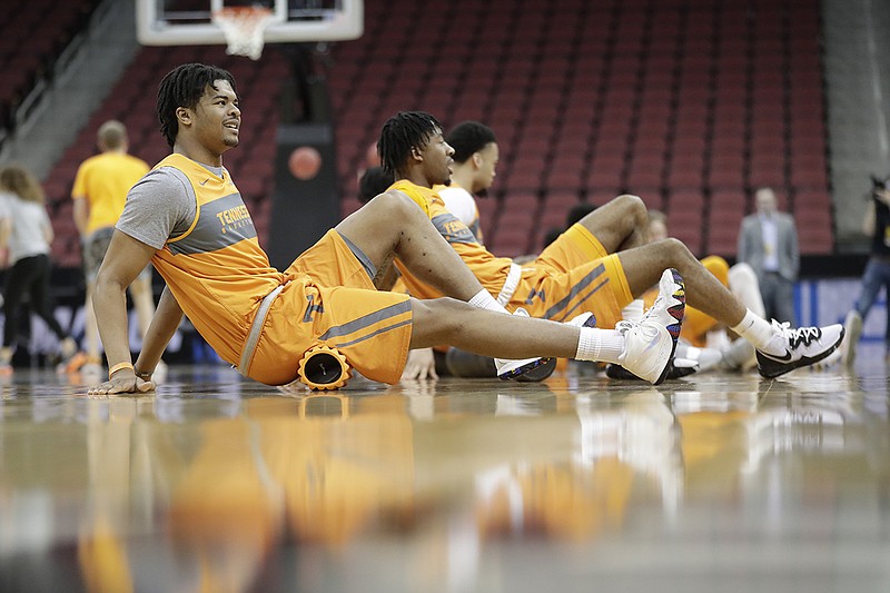 Tennessee forward Derrick Walker Jr., left, stretches during the Vols' March 27 practice in Louisville, Ky., in advance of their NCAA tournament game against Purdue.