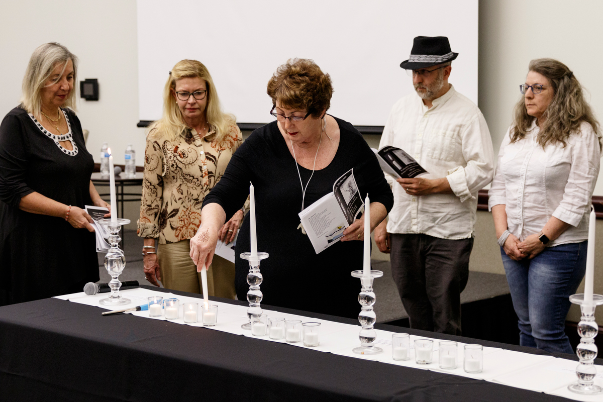 Vivian Hershey, center, lights a candle with other children of Holocaust survivors during a Yom HaShoah ceremony at the Jewish Cultural Center on Wednesday, May 1, 2019, in Chattanooga, Tenn. The tradition is held to honor the memories of the six million Jews killed during the Holocaust between 1941 and 1945.