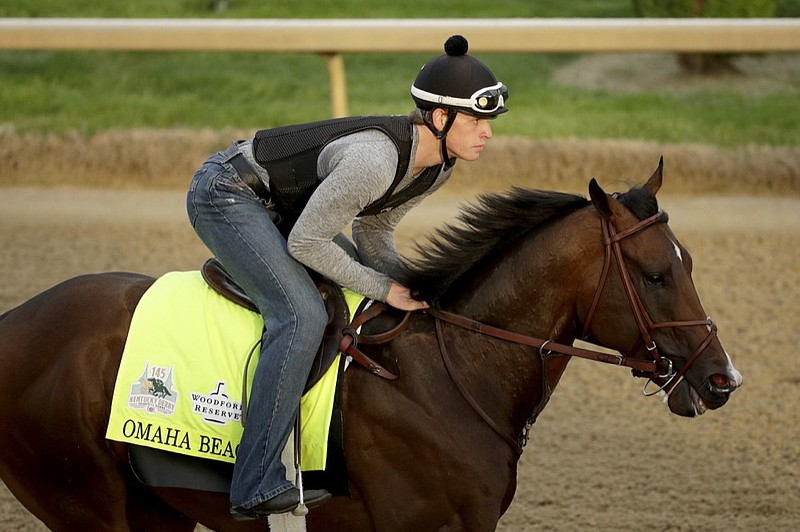 Exercise rider Taylor Cambra rides Omaha Beach during a workout Wednesday at Churchill Downs in Louisville, Ky. Although it is not expected to be life-threatening or career-ending, a breathing problem that will require surgery has forced the Kentucky Derby favorite off the Triple Crown trail.