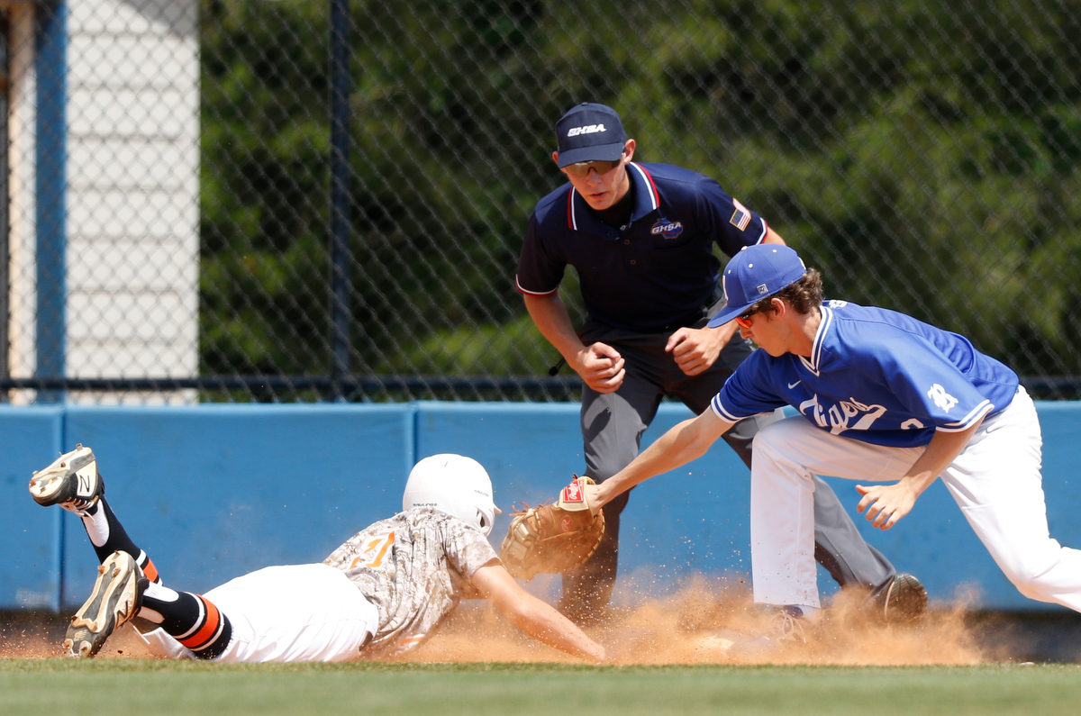 Ringgold first baseman Johnny Camillucci tries to tag Hart County runner Rafe Maxwell for a pickoff at first during the continuation of the Tigers' lightning-delayed game against Hart County at Ringgold High School on Thursday, May 2, 2019, in Ringgold, Ga.