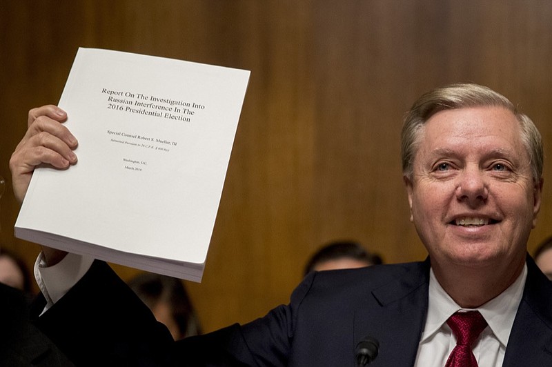 Chairman Sen. Lindsey Graham, R-S.C., holds up a copy of the Mueller Report during a Senate Judiciary Committee hearing on Capitol Hill in Washington, Wednesday, May 1, 2019, where Attorney General William Barr testifies on the Mueller Report. (AP Photo/Andrew Harnik)

