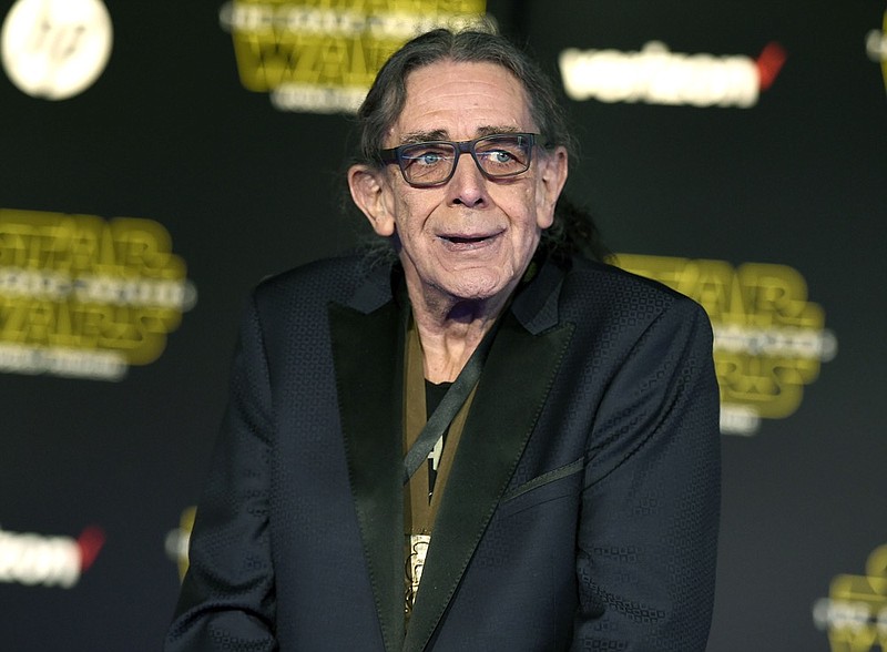 FILE - In this Dec. 14, 2015, file photo, Peter Mayhew arrives at the world premiere of "Star Wars: The Force Awakens" in Los Angeles. Mayhew, who played the rugged, beloved and furry Wookiee Chewbacca in the Star Wars films, has died. Mayhew s family said in a statement that he died at his home in Texas on Friday, April, 26, 2019. He was 74. No cause was given. (Photo by Jordan Strauss/Invision/AP, File)

