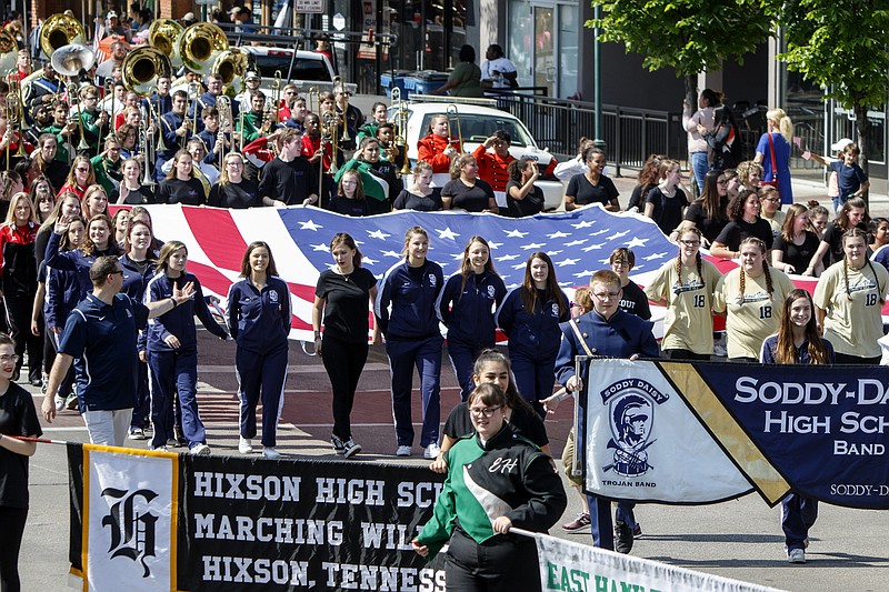 Members from various local high school marching bands carry an American flag during the 70th annual Armed Forces Day Parade on Friday, May 3, 2019 in Chattanooga, Tenn.