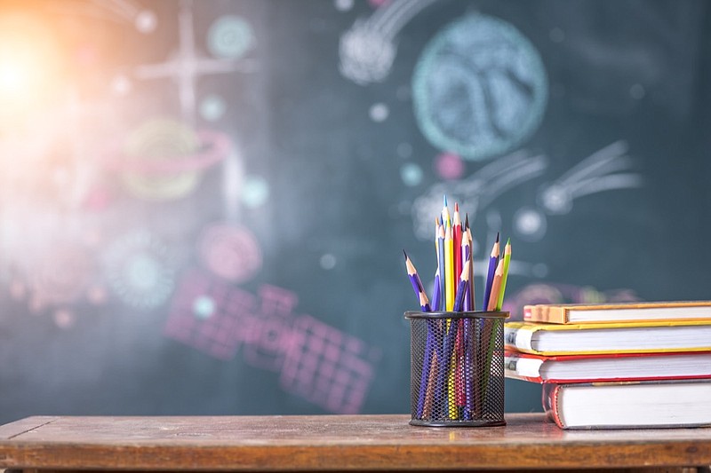 Book and colored pencil on school table school tile education tile / Getty Images