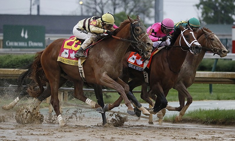 Luis Saez rides Maximum Security, center, across the finish line first, ahead of Country House and jockey Flavien Prat, left, during the Kentucky Derby on Saturday at Churchill Downs in Louisville, Ky. Country House was declared the winner after Maximum Security was disqualified after a review by race stewards.