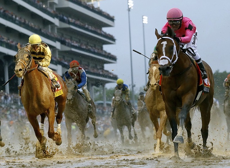 Luis Saez rides Maximum Security, right, across the finish line first as Flavien Prat on Country House, left, follows in second during Saturday's Kentucky Derby at Churchill Downs in Louisville, Ky. Country House was declared the winner after Maximum Security was disqualified for interference after a review by race stewards.