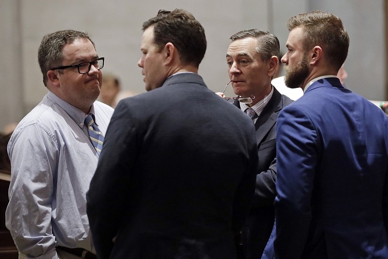 House Speaker Glen Casada, R-Franklin, second from right, talks with Rep. Matthew Hill, R-Jonesborough, left; Rep. Michael Curcio, R-Dickson, second from left; and Cade Cothren, chief of staff for Speaker Casada, right; during a Senate session Thursday, May 2, 2019, in Nashville, Tenn. (AP Photo/Mark Humphrey)