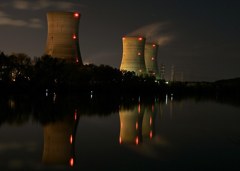 FILE - In this Nov. 2, 2006, file photo, cooling towers of the Three Mile Island nuclear power plant are reflected in the Susquehanna River in this image taken with a slow shutter speed in Middletown, Pa. The owner of Three Mile Island, site of the United States' worst commercial nuclear power accident, is acknowledging in a Wednesday, May 8, 2019 statement that it is unlikely to get a financial rescue from Pennsylvania and says it plans to go through with a shutdown starting June 1. (AP Photo/Carolyn Kaster, File)