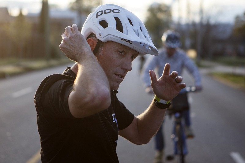 Chattanooga Police Department Sgt. Clay Tolson adjusts his helmet during the Speed Trap fundraiser along East Main Street on Friday, April 5, 2019 in Chattanooga, Tenn. The fundraiser was hosted by Handle and Bar and benefited Law Enforcement United. A minimum $5 donation got you entry into the radar races. Sgt. Tolson will take part in a fundraising ride with other CPD officers.
