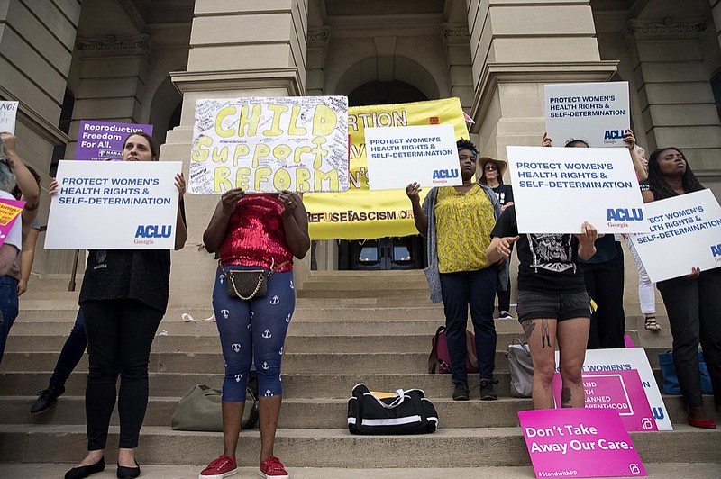 Protestors rally outside of the Georgia State Capitol building following the signing of HB 481, in Atlanta, Tuesday, May 7, 2019. Georgia Governor Brian Kemp signed legislation on Tuesday banning abortions once a fetal heartbeat can be detected. (Alyssa Pointer/Atlanta Journal-Constitution via AP)