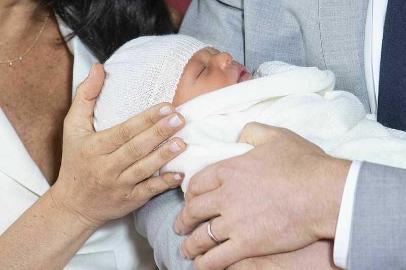 Britain's Prince Harry and Meghan, Duchess of Sussex, during a photocall with their newborn son, in St George's Hall at Windsor Castle, Windsor, south England, Wednesday May 8, 2019. (Dominic Lipinski/Pool via AP)