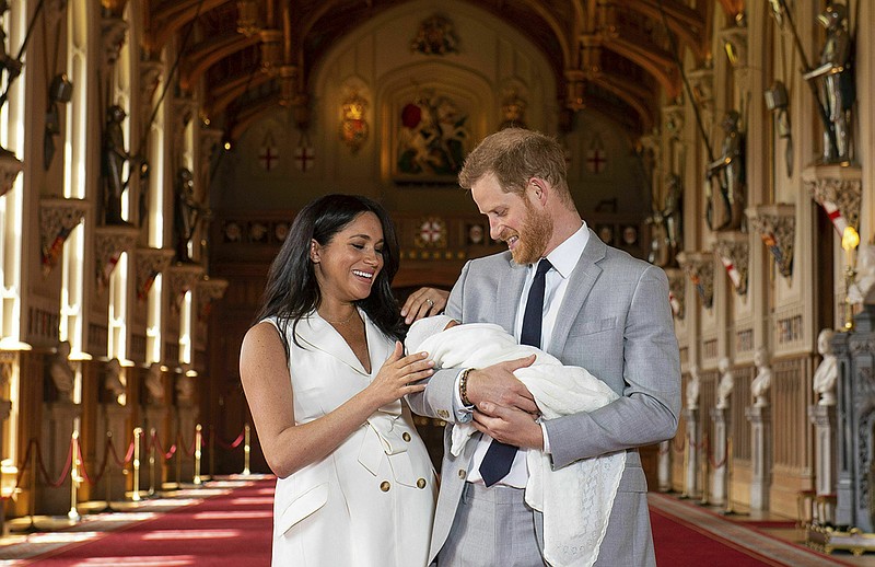 Britain's Prince Harry and Meghan, Duchess of Sussex, during a photocall with their newborn son, in St George's Hall at Windsor Castle, Windsor, south England, Wednesday May 8, 2019. (Dominic Lipinski/Pool via AP)