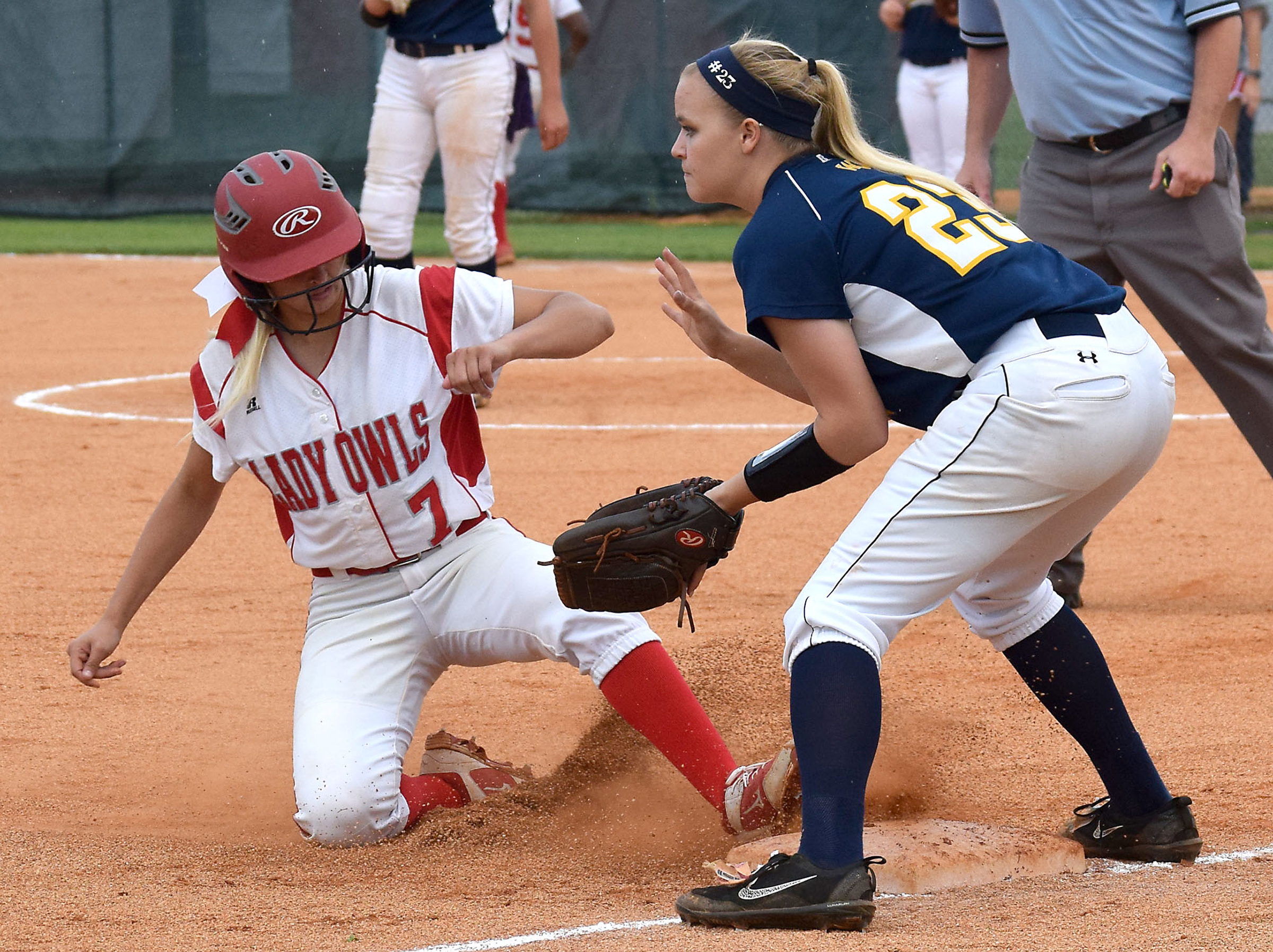 Ooltewah's Addy Keylon (7) advances to third while Walker Valley's Miranda Young (23) awaits the throw. The Walker Valley Lady Mustangs visited the Ooltewah Lady Owls in the region softball championship on May 16, 2018