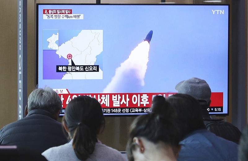 People watch a TV showing file footage of North Korea's missile launch during a news program at the Seoul Railway Station in Seoul, South Korea, Thursday, May 9, 2019. North Korea on Thursday fired at least one unidentified projectile from the country's western area, South Korea's military said, the second such launch in the last five days and a possible warning that nuclear disarmament talks could be in danger. The signs read: North Korea fired unidentified projectiles". (AP Photo/Ahn Young-joon)