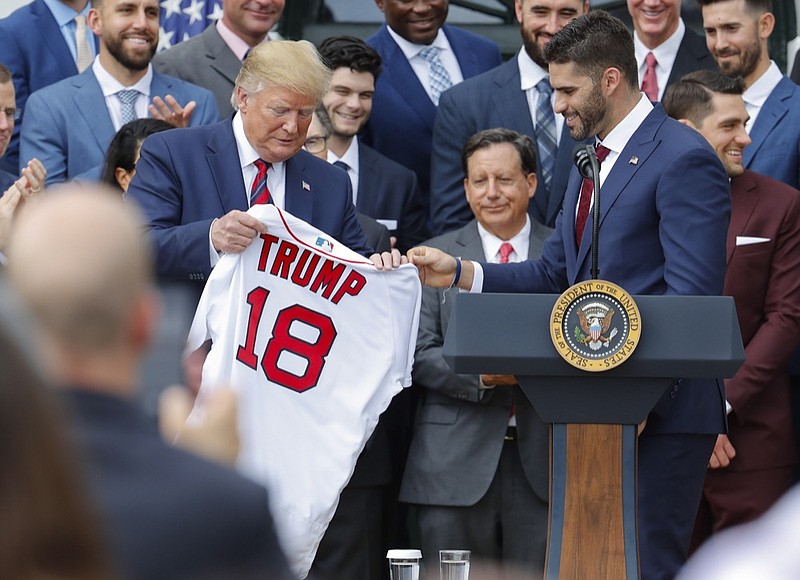 Outfielder J.D. Martinez, right, presents a team jersey to President Donald Trump, left, during a ceremony on the South Lawn of the White House in Washington, Thursday, May 9, 2019, where Trump honored the 2018 World Series Baseball Champion Boston Red Sox. (AP Photo/Pablo Martinez Monsivais)

