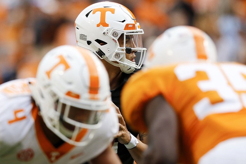 Tennessee quarterback Jarrett Guarantano, center, looks to pass during the Orange and White spring football game at Neyland Stadium on April 13.