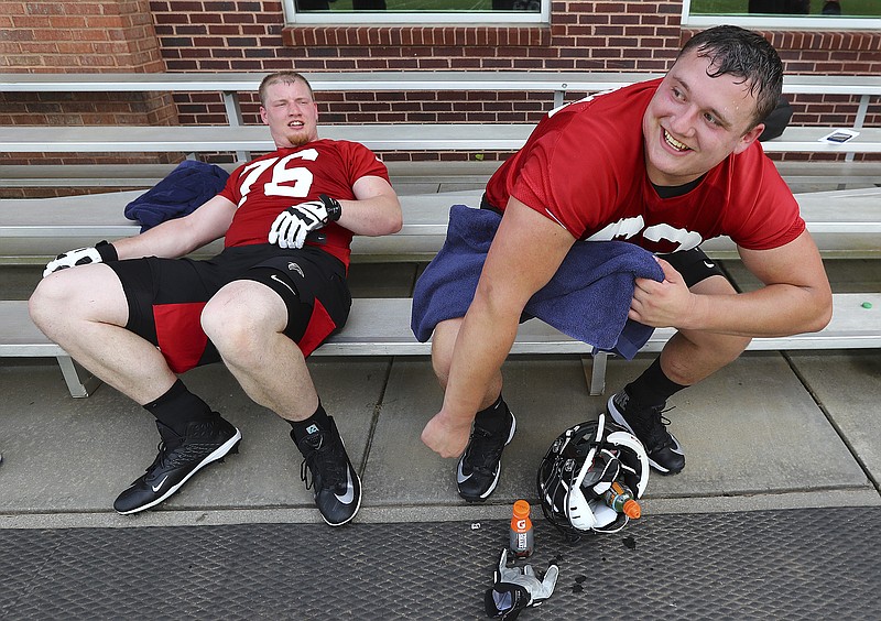 Atlanta Falcons first round picks offensive lineman Chris Lindstrom, right, and offensive tackle Kaleb McGary relax on a bench after the first day of NFL football rookie camp, Friday, May 10, 2019, in Flowery Branch, Ga. (Curtis Compton/Atlanta Journal-Constitution via AP)