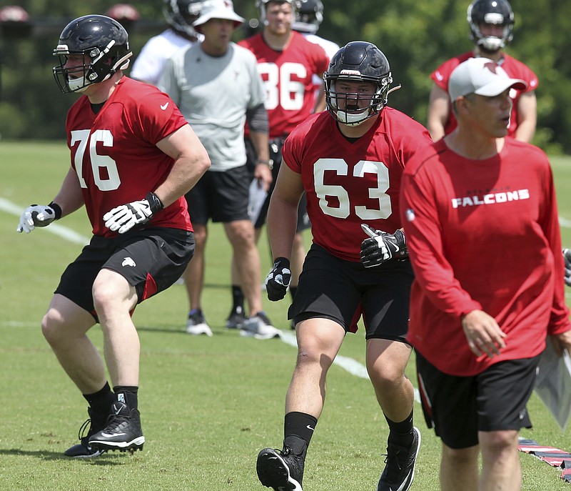 Atlanta Falcons offensive linemen and first-round draft picks Kaleb McGary (76) and Chris Lindstrom (63) go through drills Friday during the team's rookie minicamp in Flowery Branch, Ga.