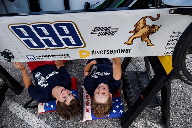 Jhon Randy, left, and Karter Norris lay beneath the go cart of their team, the Long Cane Middle School Cougar Strong Racers, in the pit at the 2019 Chattanooga Green Prix at Chattanooga State Technical Community College on Friday, May 10, 2019, in Chattanooga, Tenn. Teams from schools across Hamilton County and the Southeast competed in the electric go-cart races, which test teams' mechanical abilities, driving skill and their cart's endurance.