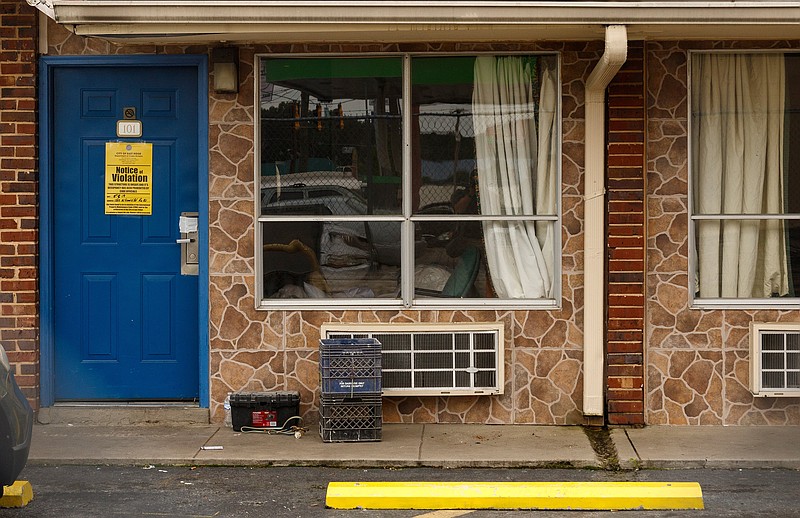 A "Notice of Violation" sign hangs on the door of a room at the Waverly Motel on Friday, May 10, 2019, in East Ridge, Tenn. The motel has been shut down by the city of East Ridge for 30 days for numerous code violations.