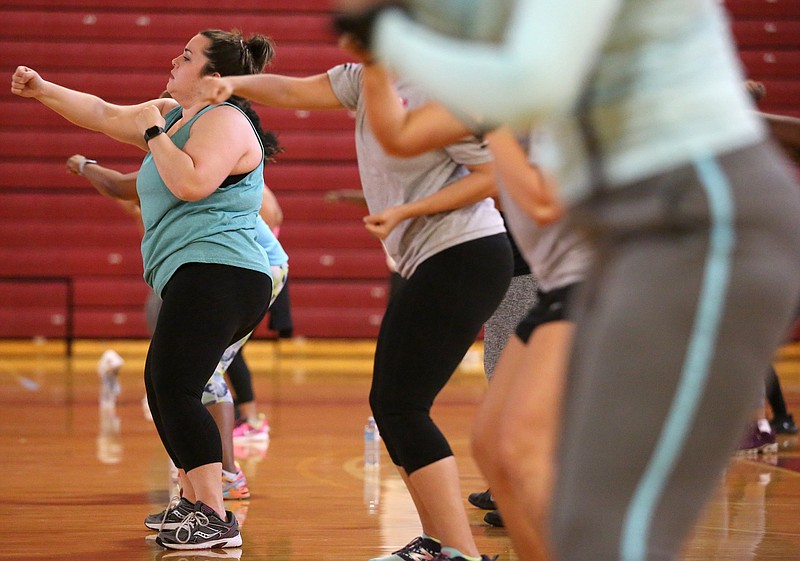 Sarah Lowe participates in a Cempa Community Care Neighborhood Workout Jam Session Monday, April 8, 2019 at The Howard School in Chattanooga, Tennessee. Lowe said she and a coworker decided to come to the event together. 