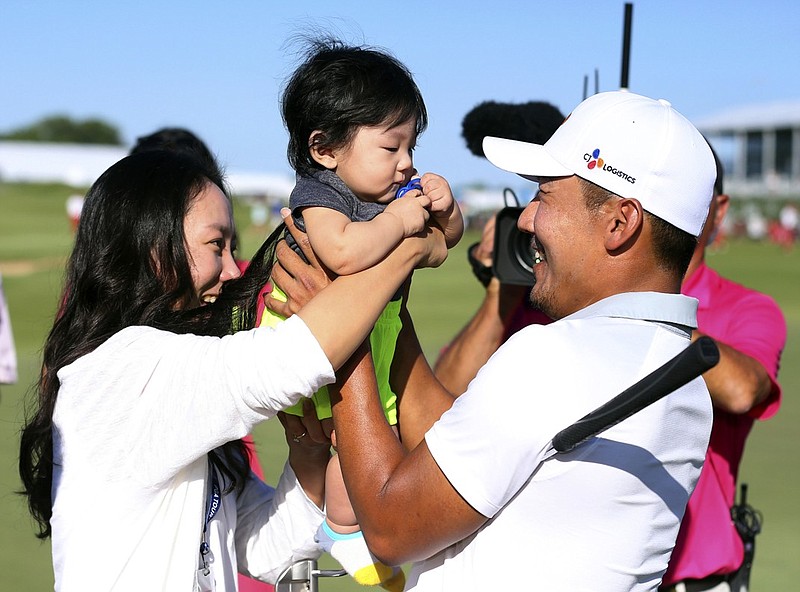 Sung Sang celebrates with his wife, Soyoung Yang, and son, Eugene Gunn Kang, after winning the Byron Nelson on Sunday in Dallas for the first PGA Tour win of his career.