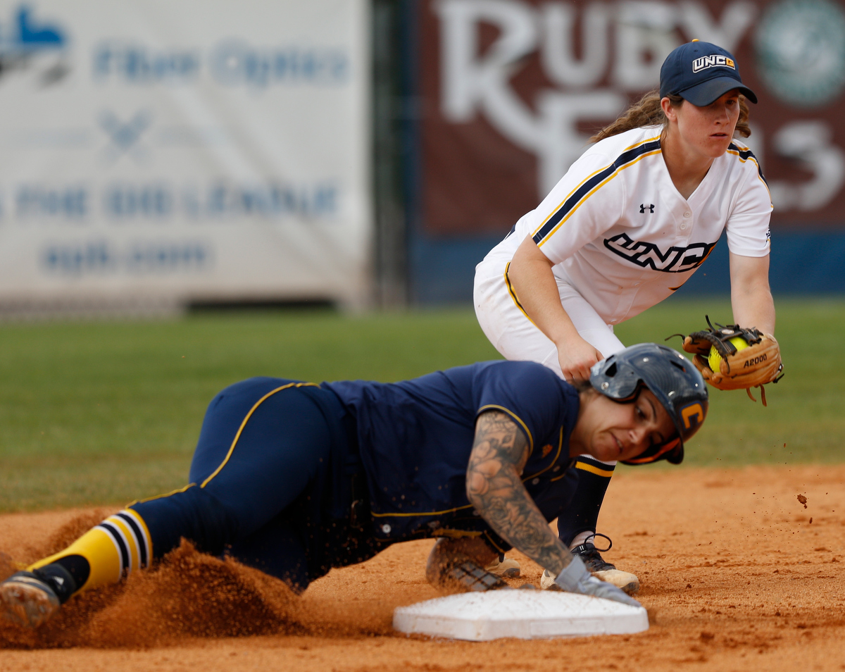 UTC's Amanda Beltran slides into second base around the tag by UNC Greensboro's Monica Pepe during Saturday's SoCon title round.