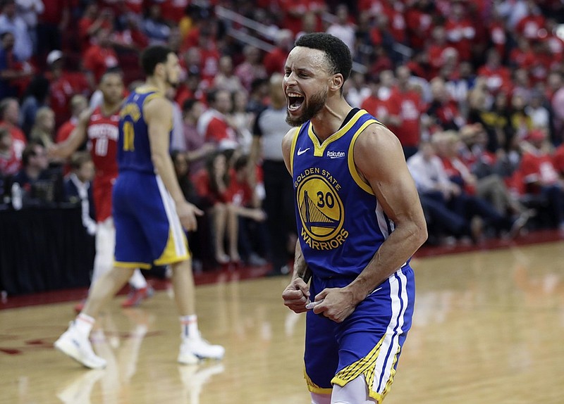 Golden State Warriors guard Stephen Curry celebrates his team's victory against the Houston Rockets in Game 6 of their Western Conference semifinal series Friday night in Houston. Golden State won 118-113 to clinch the series and will face the Portland Trail Blazers in the conference finals.