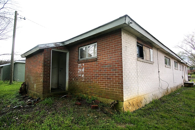 Staff photo by Erin O. Smith / Vacant duplexes are boarded up in the 2000 block of Milne Street Monday, March 25, 2019 in Chattanooga, Tennessee. The duplexes were built in the 1940s and 1950s for returning World War II veterans and their families, but they now show years of neglect.