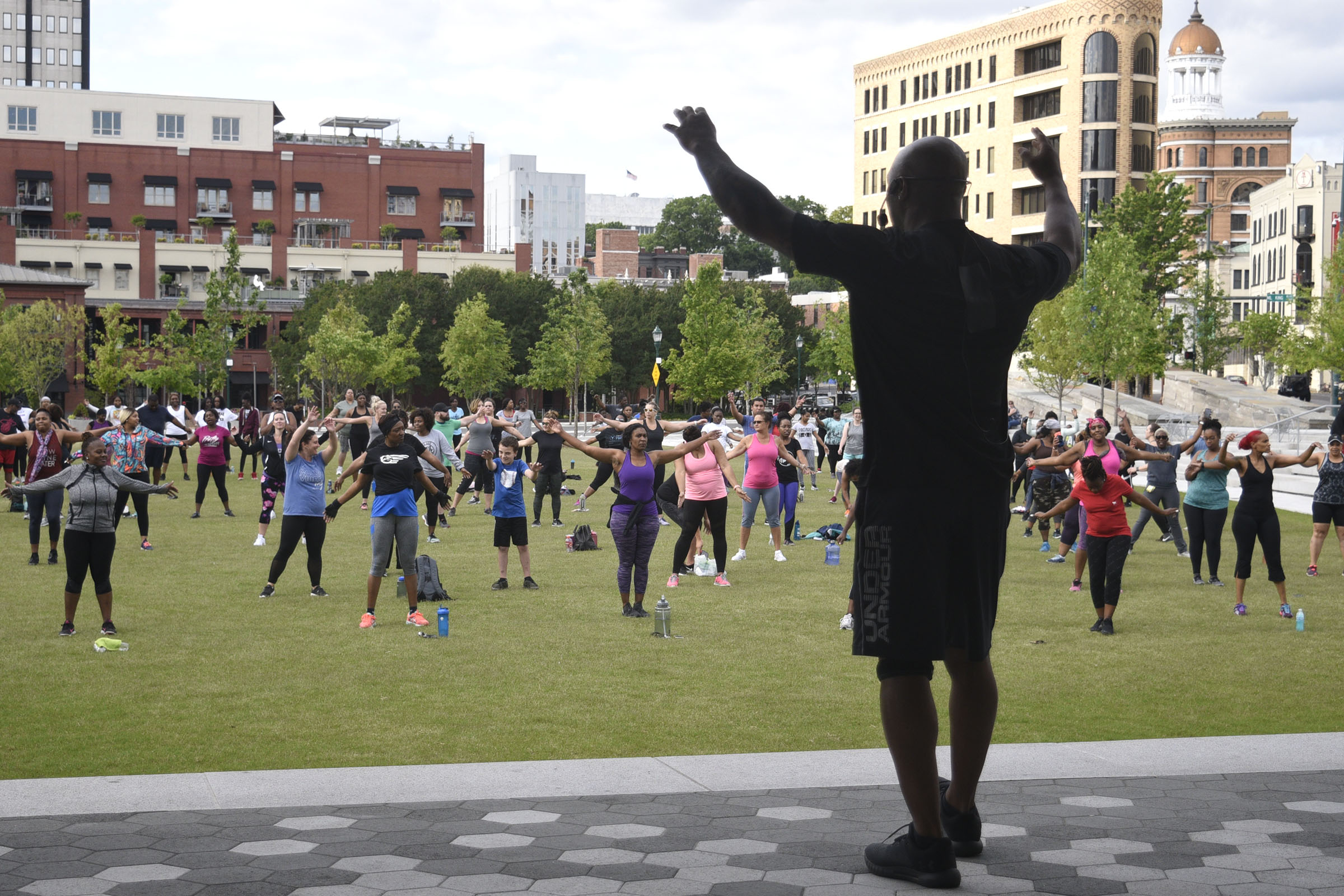Instructor Tobe Smith gets everyone to stretch before the workout. Cempa Community Care and Hospice of Chattanooga hosted the Third Neighborhood Workout Jam Session at Miller Park on May 13, 2019. Mayor Andy Berke addressed the participants.