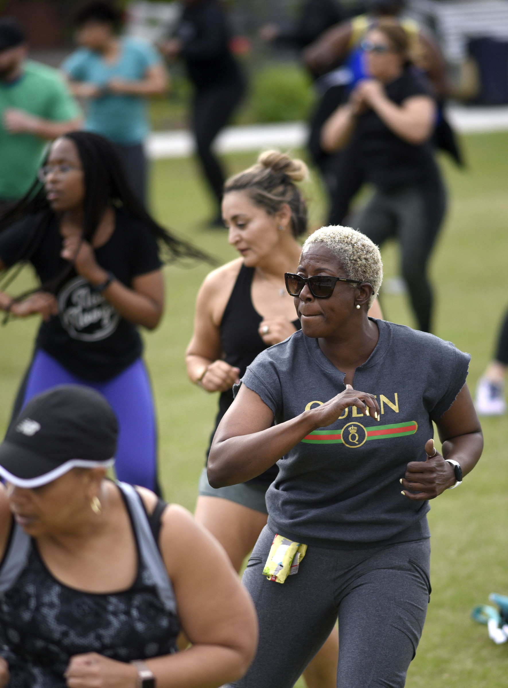 Ramona McCoy, second from front, concetrates on her workout. Cempa Community Care and Hospice of Chattanooga hosted the Third Neighborhood Workout Jam Session at Miller Park on May 13, 2019. Mayor Andy Berke addressed the participants.