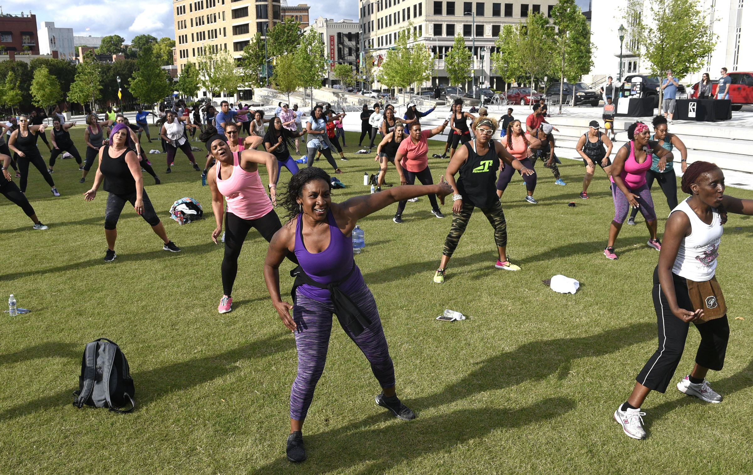 Fitness enthusiasts follow the lead of instructor Tobe Taylor. Cempa Community Care and Hospice of Chattanooga hosted the Third Neighborhood Workout Jam Session at Miller Park on May 13, 2019. Mayor Andy Berke addressed the participants.