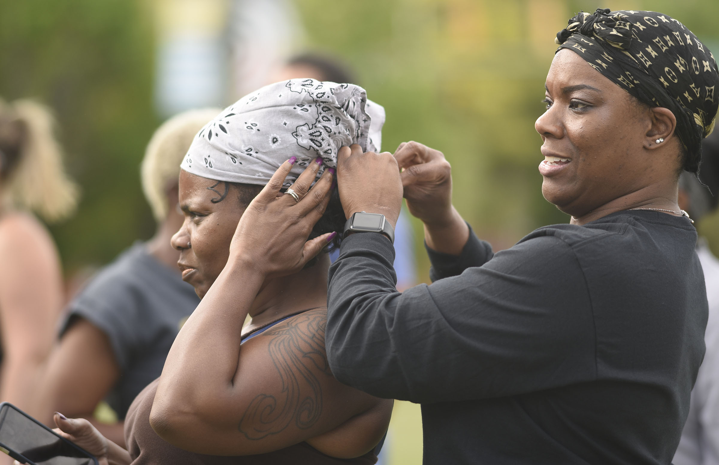 Tamekia Brewer, right, adjusts the bandana of Valencia Brewer before their workout. Cempa Community Care and Hospice of Chattanooga hosted the Third Neighborhood Workout Jam Session at Miller Park on May 13, 2019. Mayor Andy Berke addressed the participants.