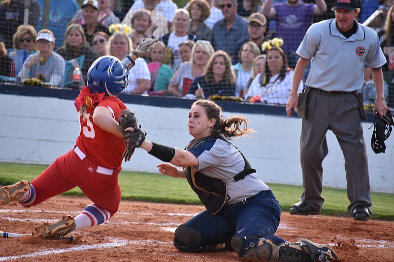 Warren County runner Emily Mikkola (13) scores past Walker Valley catcher Hannah Kate Singleton in the sixth inning of the Region 3-AAA semifinal Monday in Cleveland. The Lady Pioneers won 4-0 on the road and will take on Ooltewah for the region championship Wednesday.