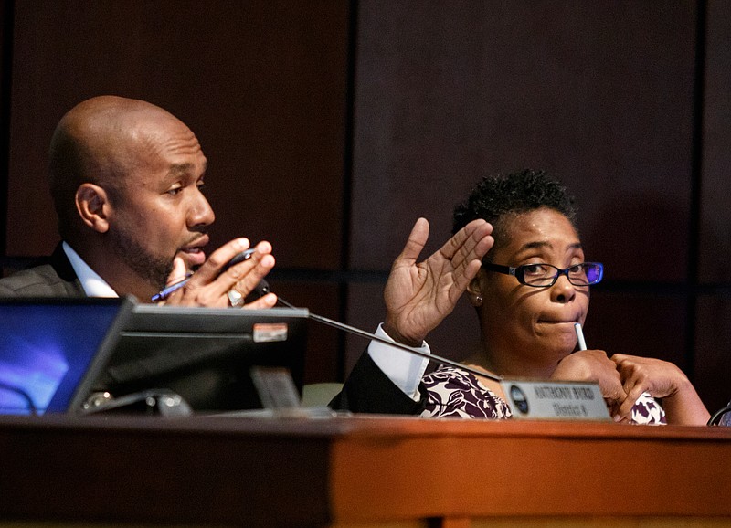 Councilor Anthony Byrd, left, speaks next to councilor Demetrus Coonrod during a meeting in the Chattanooga City Council chamber on Tuesday, May 14, 2019, in Chattanooga, Tenn. A proposed $263.8 million city budget for fiscal year 2020 includes funding for infrastructure upgrades.