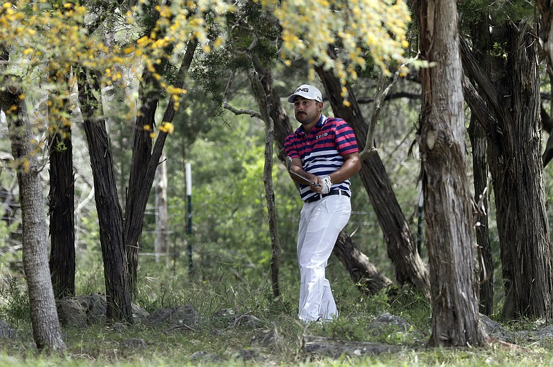 Stephan Jaeger plays a shot from the woods on the ninth hole during the second round of the Texas Open golf tournament, Friday, April 5, 2019, in San Antonio. (AP Photo/Eric Gay)