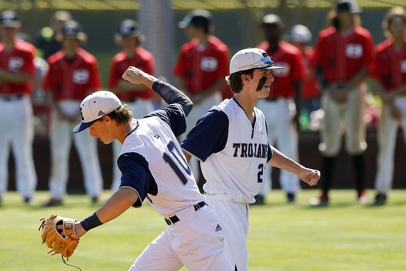 Gordon Lee's Tanner Wilson, right, greets teammate Cade Peterson as they take the field before the first game of their GHSA Class A public state semifinal series against Bowdon last week in Chickamauga, Georgia. Gordon Lee will face Schley County in the title series starting Monday in Savannah.