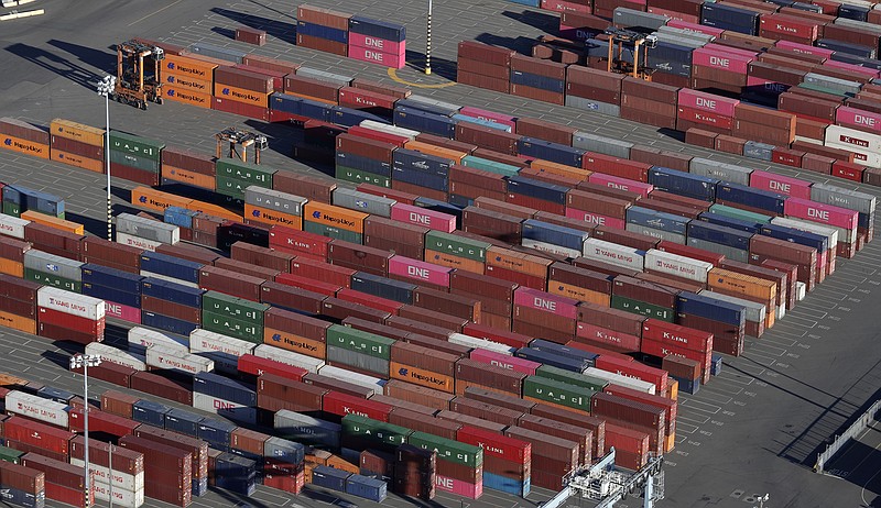 FILE - In this March 5, 2019, file photo, cargo containers are staged near cranes at the Port of Tacoma, in Tacoma, Wash. The 25% tariffs President Donald Trump has imposed on thousands of Chinese-made products have business owners trying to determine how or whether they can limit the damage to profits from the import duties. (AP Photo/Ted S. Warren, File)