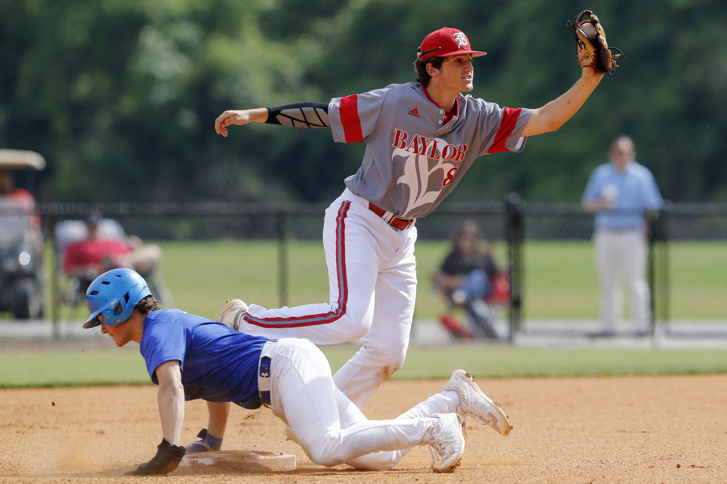 Staff photo by C.B. Schmelter / Baylor's Cooper Kinney (8) holds up his glove after helping to pick off Memphis University School's Will Portera (5) at second base for the second out in the top of the first inning during Game 1 of a double header in the Division II-AA quarterfinals at Wyatt McMahan Field on the campus of Baylor Schoolon Wednesday, May 15, 2019 in Chattanooga, Tenn.