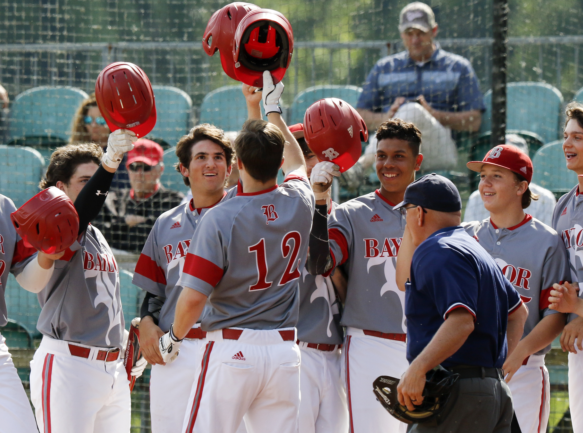Baylor's Colin Ahearn (12) celebrates at home plate with his teammates after hitting a grand slam in the bottom of the first inning against Memphis University School during Game 1 of a double header in the Division II-AA quarterfinals at Wyatt McMahan Field on the campus of Baylor Schoolon Wednesday, May 15, 2019 in Chattanooga, Tenn.