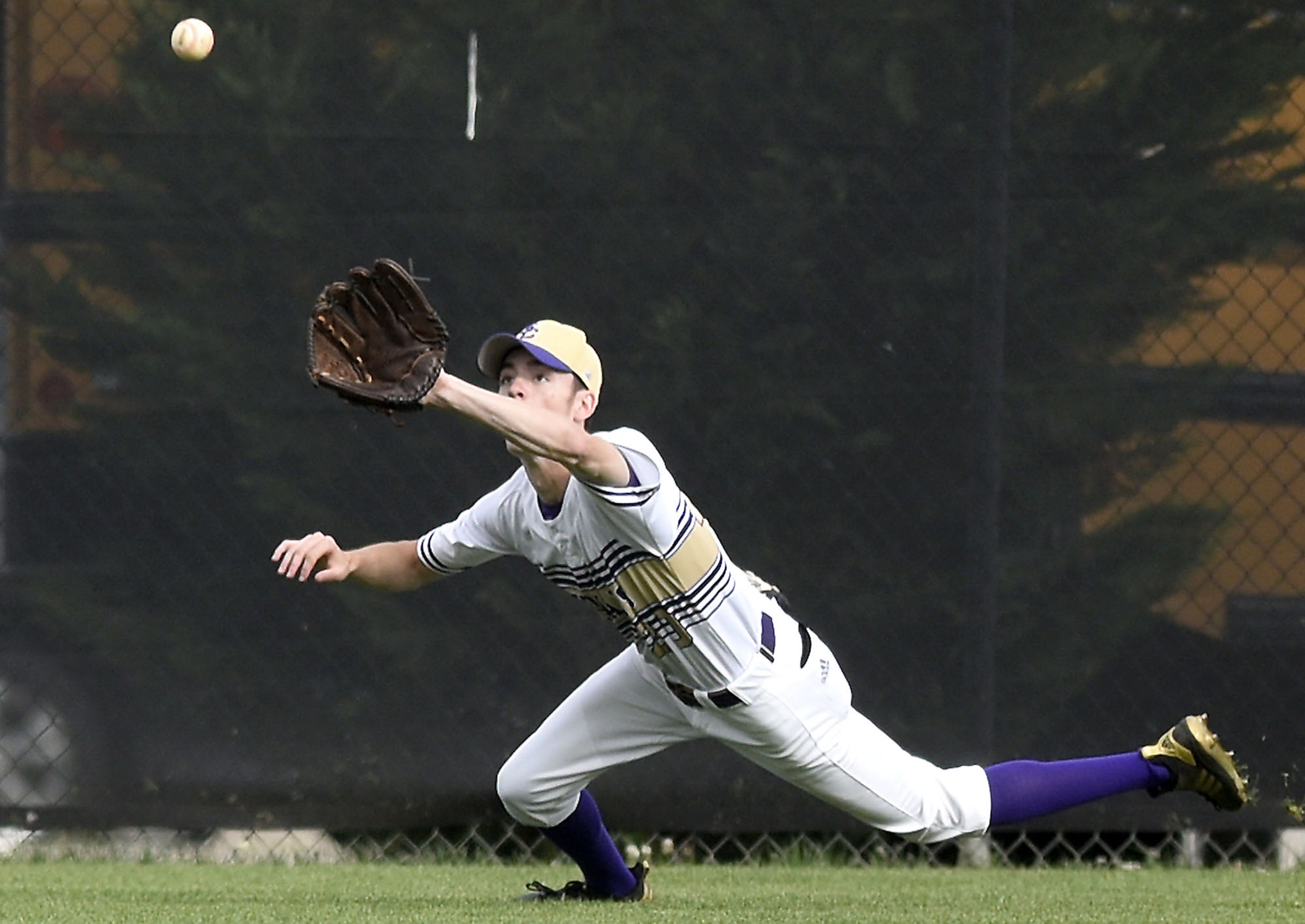 Sequatchie's Michael Cooper (20) dives to catch a Grundy flyball. The Sequatchie County Indians hosted the Grundy County Yellow Jackets in the Region 4-AA baseball championship on May 15, 2019.