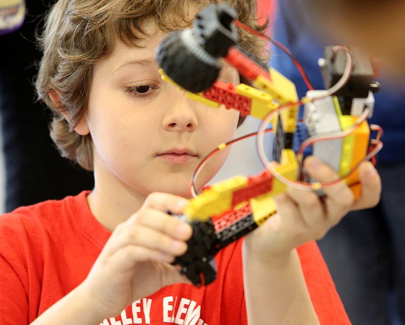 Jordan Tyler, a third grader at Middle Valley Elementary, fixes a robot before completing a task during the Amazon STEM Jubilee at Chattanooga State Community College Wednesday, May 15, 2019 in Chattanooga, Tennessee. Several thousand students participated in the event.