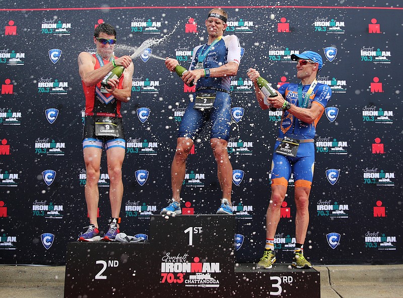 From left, Jackson Laundry, Andrew Starykowicz and Adam Otstot spray each other with sparkling cider in celebration following their Ironman 70.3 Chattanooga races Sunday, May 20, 2018 in Chattanooga, Tenn. Landry, Starykowicz and Otstot finished second, first and third respectively. 