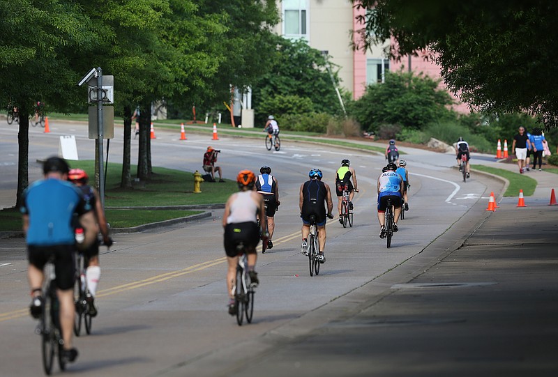 Cyclists ride up Riverfront Parkway to begin the bike portion of the Sunbelt Bakery Ironman 70.3 Chattanooga on Sunday morning.