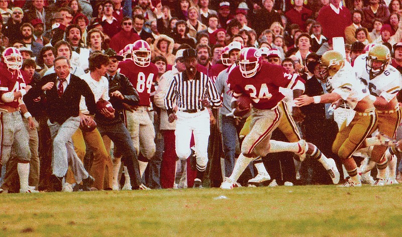 Vince Dooley, left, Georgia's football coach at the time, races down the sideline as eventual 1982 Heisman Trophy winner Herschel Walker breaks loose for a sizable gain against Georgia Tech inside Sanford Stadium.