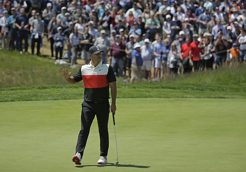Brooks Koepka celebrates a birdie putt during the first round of the PGA Championship on Thursday in Farmingdale, N.Y. Koepka tied the course record with a 63 at Bethpage Black.