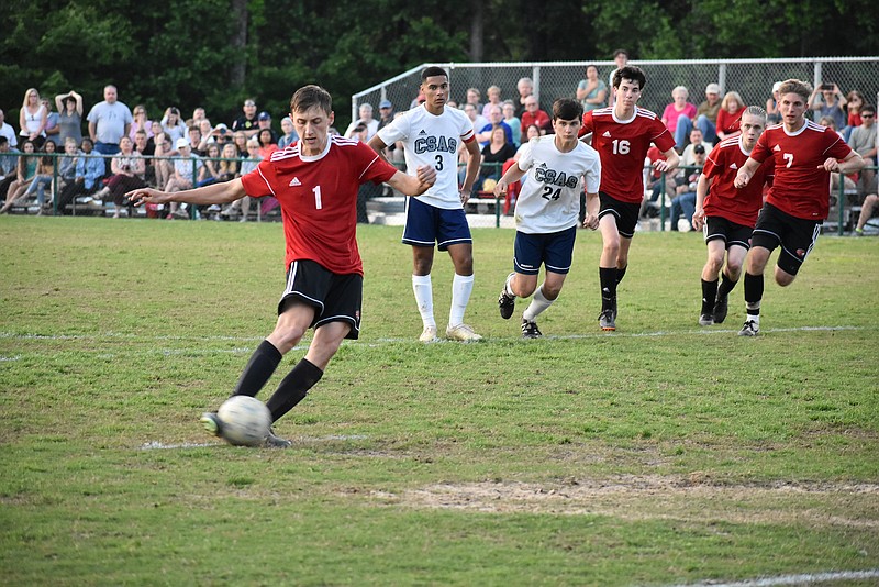 Signal Mountain senior George Coogan scores on a penalty kick in the 99th minute of the Region 3-A title game against Arts & Sciences on Thursday night. It was Coogan's second goal of the game and led the host Eagles to a 4-3 overtime win.