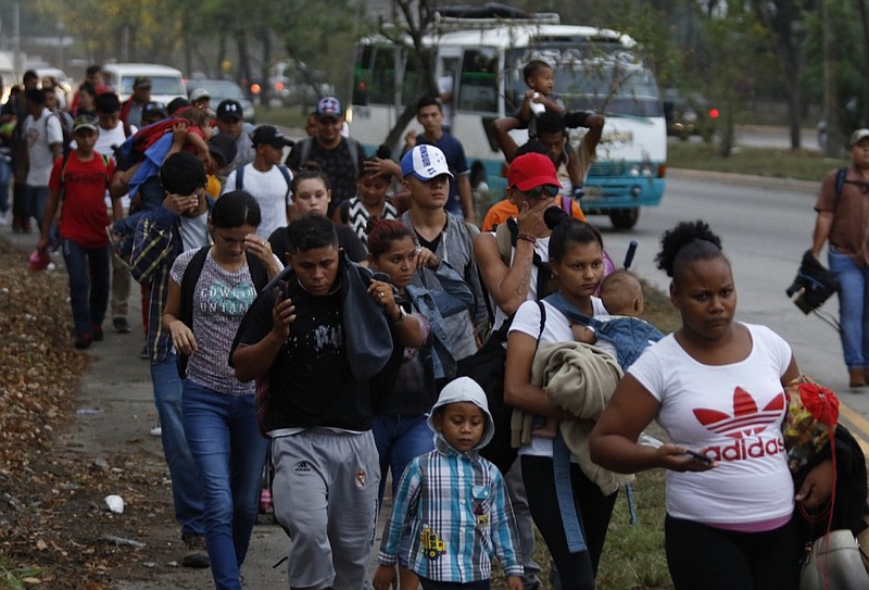 In this April 10, 2019, file photo, migrants walk at dawn as part of a new caravan of several hundred people sets off in hopes of reaching the distant United States, in San Pedro Sula, Honduras. "A situation of insecurity moves people," said National Human Rights Commissioner Roberto Herrera C ceres. "It forces internal displacement that later turns into forced migrations." (AP Photo/Delmer Martinez, File)